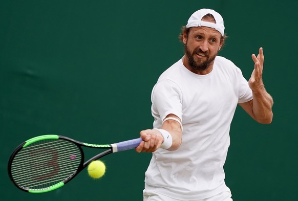 epa07699083 Tennys Sandgren of the USA in action against Fabio Fognini of Italy during their third round match at the Wimbledon Championships at the All England Lawn Tennis Club, in London, Britain, 0 ...