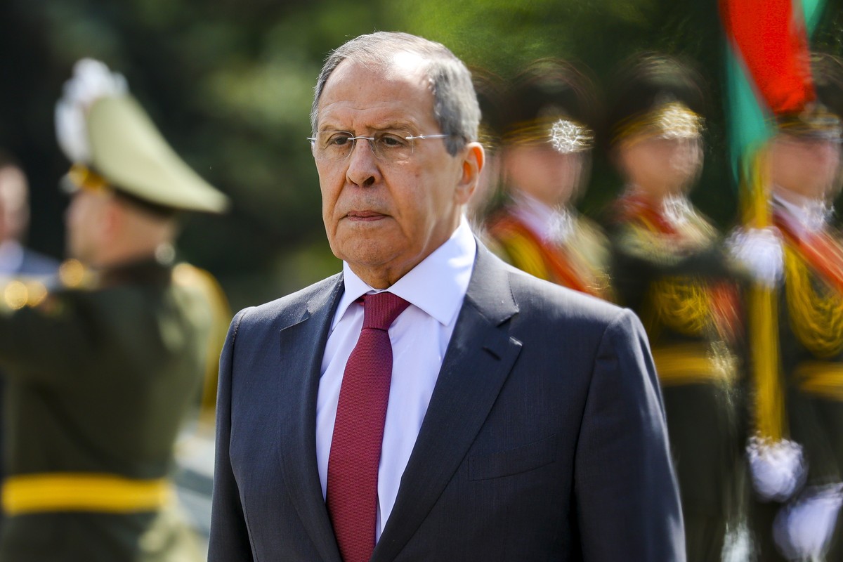 In this handout photo released by Russian Foreign Ministry Press Service, Russia's Foreign Minister Sergey Lavrov takes part in a laying ceremony at the Eternal Flame after the meeting of the Cou ...