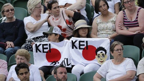 Fans of Japan's Kei Nishikori watch him play against Kazakhstan's Mikhail Kukushkin in a men's singles match during day seven of the Wimbledon Tennis Championships in London, Monday, Ju ...
