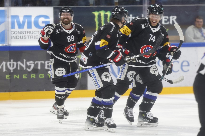 Goteron's Andrey Bykov, left, celebrates after his goal that made it 2-1 alongside teammates Sandro Schmid and Andreas Borgmann in the first ever National League ice hockey semifinal between HC F...