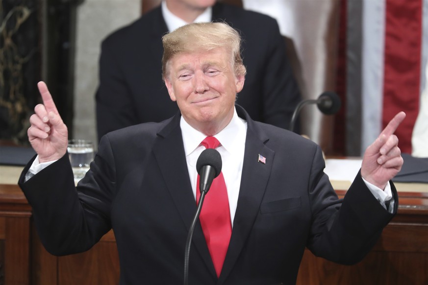 President Donald Trump gestures as a conductor as people in the chamber sing &quot;Happy Birthday&quot; to Judah Samet as he delivers his State of the Union address to a joint session of Congress on C ...