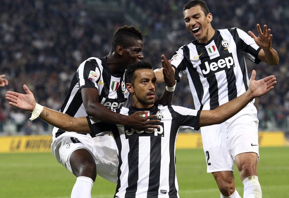 Juventus striker Fabio Quagliarella, center, celebrates with his teammates Paul Pogba, left, and Lucio after scoring, during a Serie A soccer match between Chievo Verona and Juventus, in Turin, Italy, ...