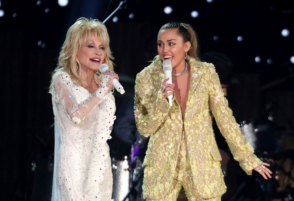 FILE - Dolly Parton, left, and Miley Cyrus perform "Jolene" at the 61st annual Grammy Awards in Los Angeles on Feb. 10, 2019. (Photo by Matt Sayles/Invision/AP, File)
Dolly Parton,Miley Cyru ...