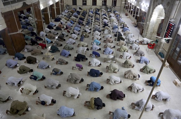 People attend evening prayers while maintaining a level of social distancing to help avoid the spread of the coronavirus, at a mosque in Karachi, Pakistan, Sunday, April 19, 2020. Pakistan Prime Minis ...