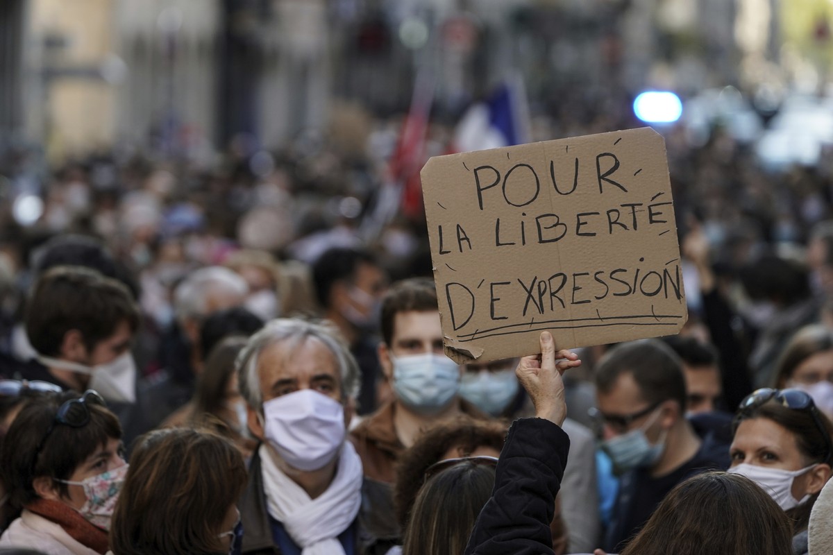 A person holds up a banner that reads: 'For the freedom of speech', during a demonstration in Lyon, central France, Sunday, Oct. 18, 2020. Demonstrators in France on Sunday took part in gath ...