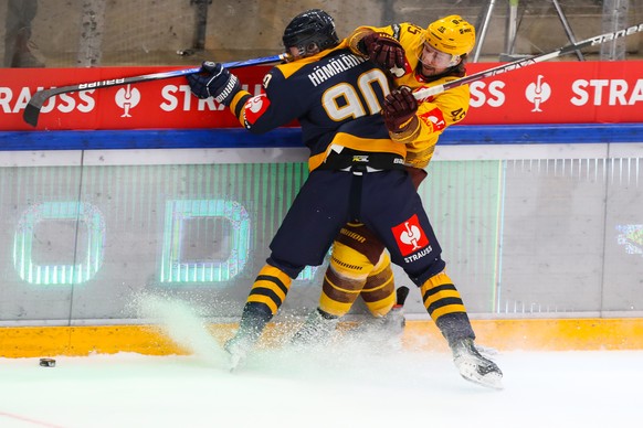 Lukko&#039;s Lenni Haemaelaeinen, front, checking Servette&#039;s Sami Vatanen during the second leg of the Champions Hockey League semi final game between Finland&#039;s Rauma Lukko and Switzerland&# ...