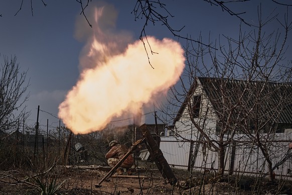 FILE - Ukrainian soldiers fire a mortar at Russian positions on the frontline near Bakhmut, Donetsk region, Ukraine, Sunday, March 26, 2023. Europe?s biggest armed conflict since World War II is poise ...
