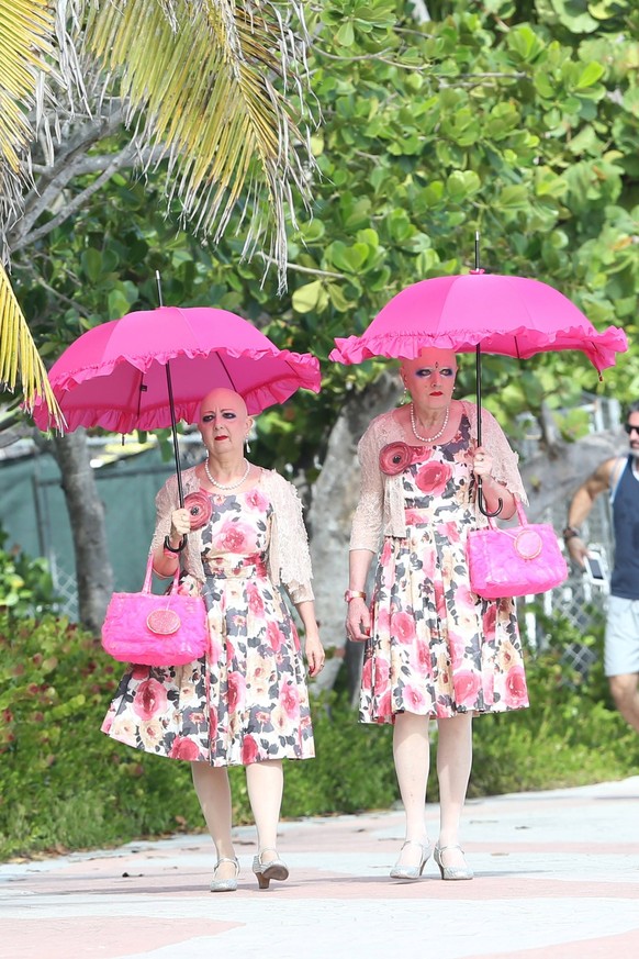 German performance artists Eva and Adele take a walk in Miami in matching floral dresses and umbrellas 145528, German performance artists Eva and Adele take a walk in Miami in matching floral dresses  ...