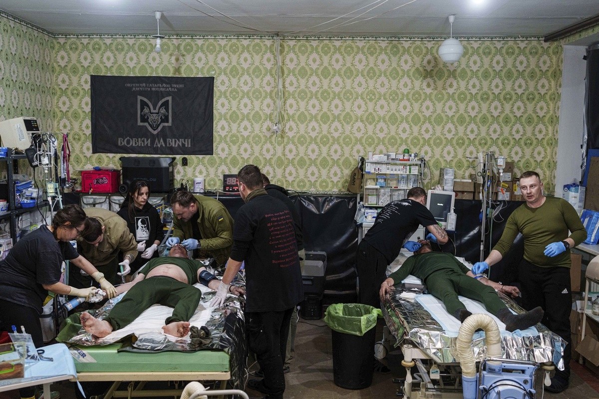 Medics treat injured Ukrainian servicemen at Medical Service "Ulf" of the 108th Separate Battalion "Da Vinci Wolves" on Pokrovsk direction, Ukraine, Monday, Dec. 23, 2024. (AP Phot ...