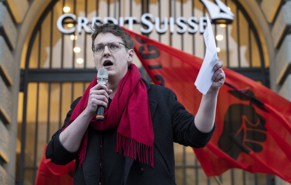 epa10534148 Nicola Siegrist, President of Juso party, speaks to people protesting on occasion of the takeover of Credit Suisse by UBS, in Zurich, Switzerland, 20 March 2023. Swiss bank UBS takes over  ...