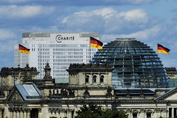 The bed skyscraper of the Berliner Charite can be seen behind the Reichstag building in Berlin, Germany, Tuesday, Aug.25, 2020.. In the clinic the Russian oppositional Nawalny is treated. Doctors of t ...