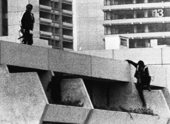 On the alert, West German policemen in sportswear with bulletproof vests underneath and armed with machine guns take position on the roof of the Munich Olympic Village building where armed Palestinian ...