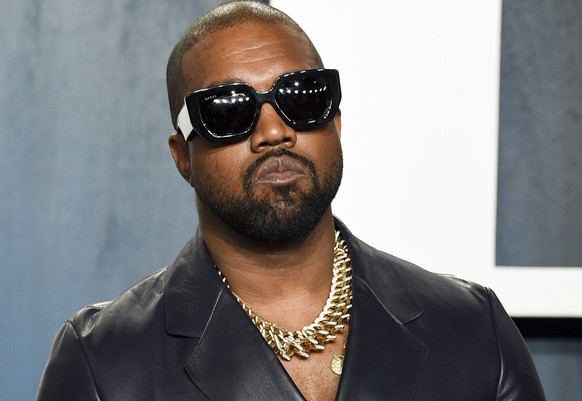 FILE - Kanye West appears at the Vanity Fair Oscar Party in Beverly Hills, Calif., on Feb. 9, 2020. Police say they are investigating after a battery report was filed Thursday, Jan. 13, 2022, against  ...