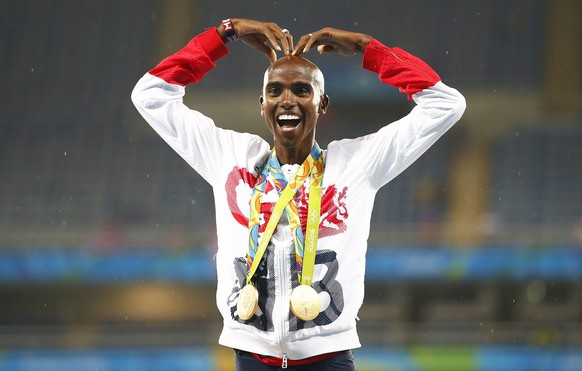 epa05504271 Mo Farah of Britain poses with his gold medals on the podium after winning the men&#039;s 5000m final of the Rio 2016 Olympic Games Athletics, Track and Field events at the Olympic Stadium ...