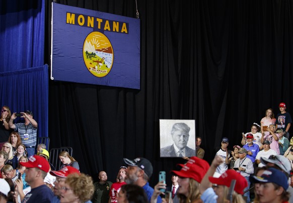 A portrait of President Donald Trump is held up before he arrives to speak at rally at the Four Seasons Arena at Montana ExpoPark, Thursday, July 5, 2018, in Great Falls, Mont.,. (AP Photo/Carolyn Kas ...
