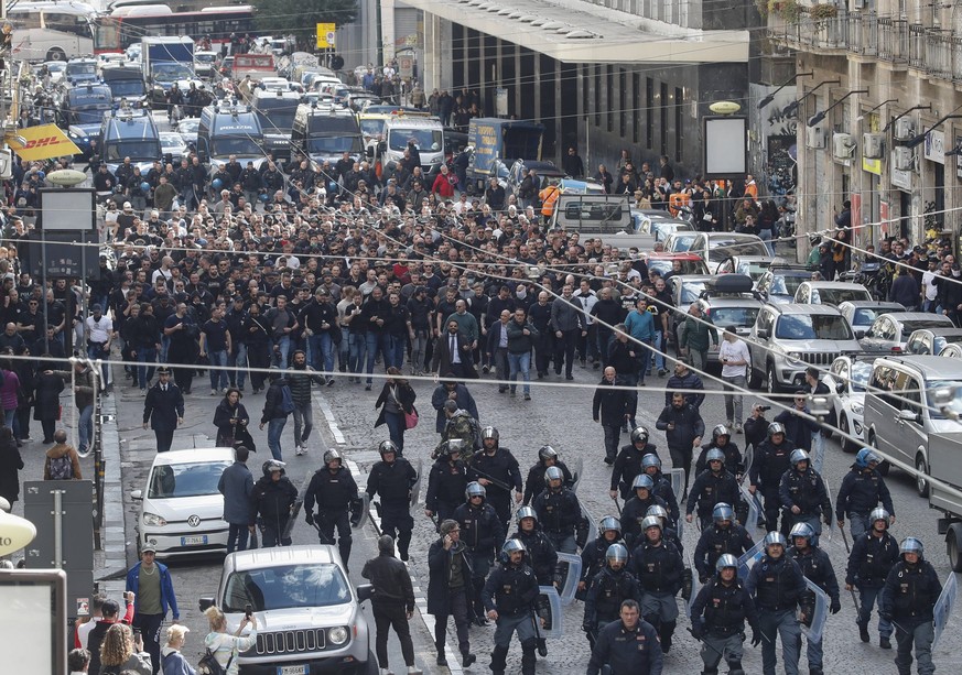 Italian police follow Eintracht Frankfurt fans walking through the streets of the city of Naples before the UEFA Champions League round of 16 return match between SSC Napoli and Eintracht Frankfurt. P ...