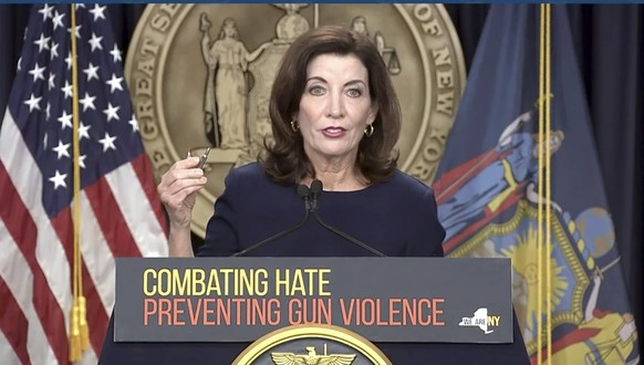 In this image taken from video, New York Gov. Kathy Hochul shows bullets similar those used in the the Buffalo supermarket shooting, during a news conference, Wednesday, May 18, 2022, in New York. New ...