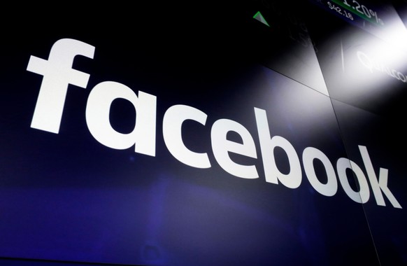 FILE - This March 29, 2018, file photo shows the Facebook logo on screens at the Nasdaq MarketSite, in New York&#039;s Times Square. Facebook, Google and other platforms are taking unprecedented steps ...
