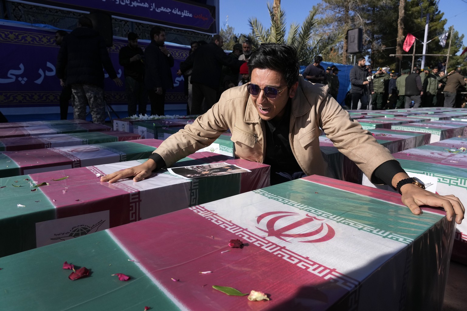 A man mourns over the flag-draped coffin of his sister who was killed in Wednesday&#039;s bomb explosion, during the victims funeral ceremony in the city of Kerman about 510 miles (820 km) southeast o ...