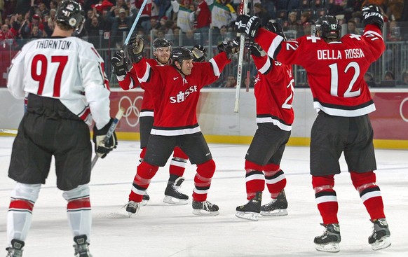 In this photo provided by the Canadian Olympic Committee, Switzerland&#039;s men&#039;s ice hockey team celebrates their first goal against Canada at the Winter Olympics in Turin, Italy, Saturday, Feb ...