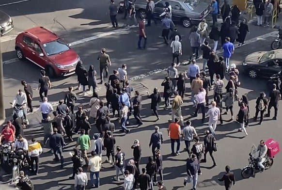 In this frame grab from video taken by an individual not employed by the Associated Press and obtained by the AP outside Iran shows people block an intersection during a protest to mark 40 days since  ...