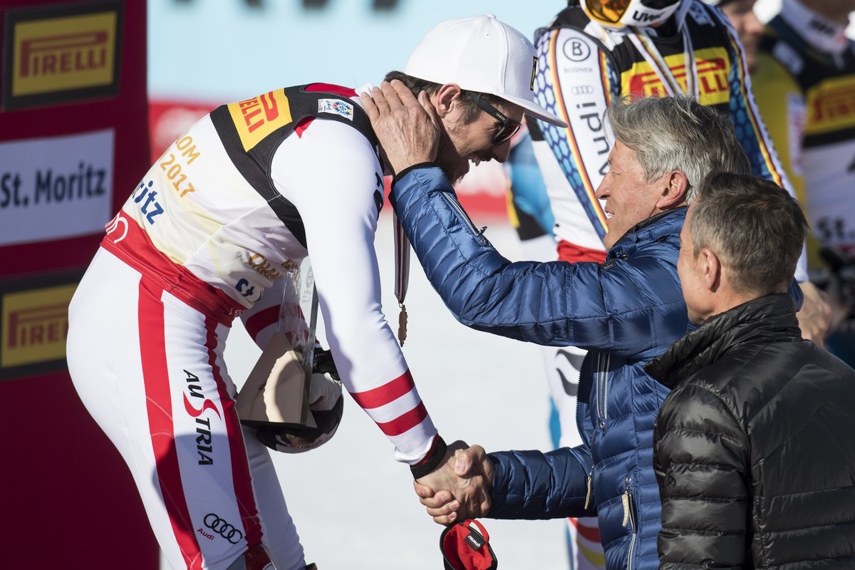 Winner Marcel Hirscher of Austria, left, celebrates with the Gold medal for Slalom and Bernhard Russi, center, former Swiss ski racer and Matthias Hueppi, right, commentator for the Swiss TV, SRF, dur ...