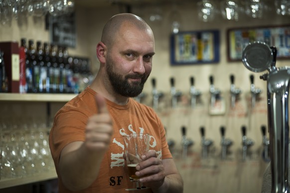 In this Friday, May 22, 2015 photo, Stanislav Obraztsov gestures as he speaks during an interview at his craft beer bar in Moscow. The rubles crash in value against the dollar last year helped Russia ...