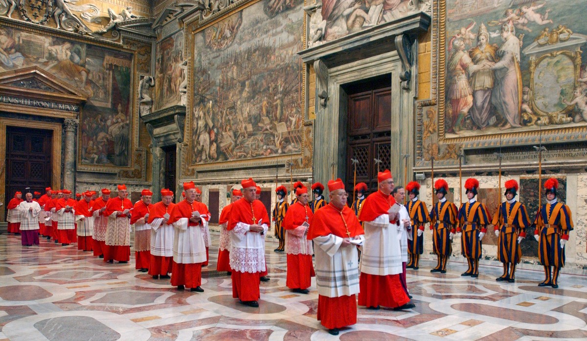 FILE - In this photo from files taken on April 18, 2005 and released by the Vatican paper L'Osservatore Romano, Cardinals walk in procession to the Sistine Chapel at the Vatican, at the beginning ...