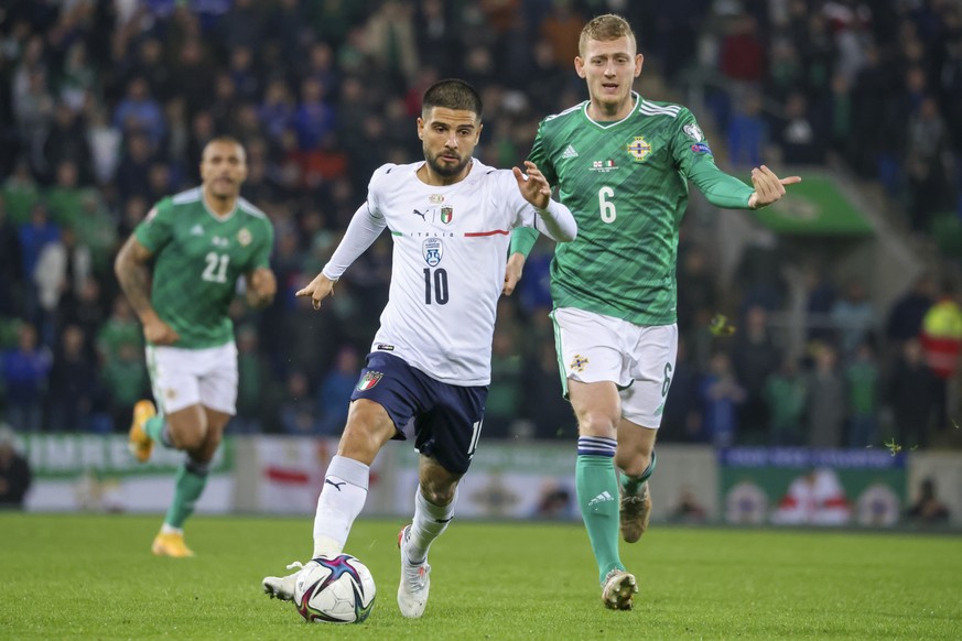 Lorenzo Insigne of Italy and George Saville of Northern Ireland, right, compete for the ball during the World Cup 2022 group C qualifying soccer match between Northern Ireland and Italy at Windsor Par ...