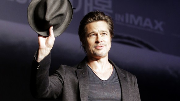 FILE - In this Nov. 13, 2014 file photo, actor Brad Pitt waves upon his arrival for a press conference for his latest film &quot;Fury&quot; in Seoul, South Korea. Pitt will star in a romantic thriller ...