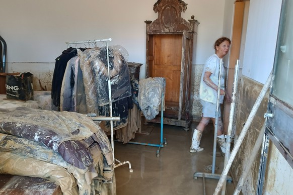 Mud covers clothes in an apartment in Senigallia, Marche region, Italy, Friday Sept. 16, 2022. Floodwaters triggered by heavy rainfall swept through several towns in a hilly region of Marche, central- ...