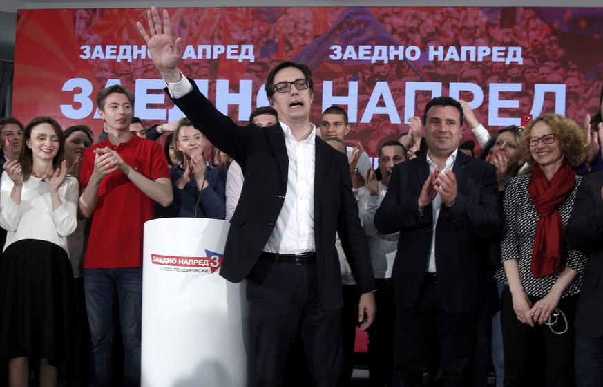 Stevo Pendarovski, center, a presidential candidate of the ruling coalition led by the Social-democrats, celebrate his victory in the presidential election, in Skopje, North Macedonia, late Sunday, Ma ...