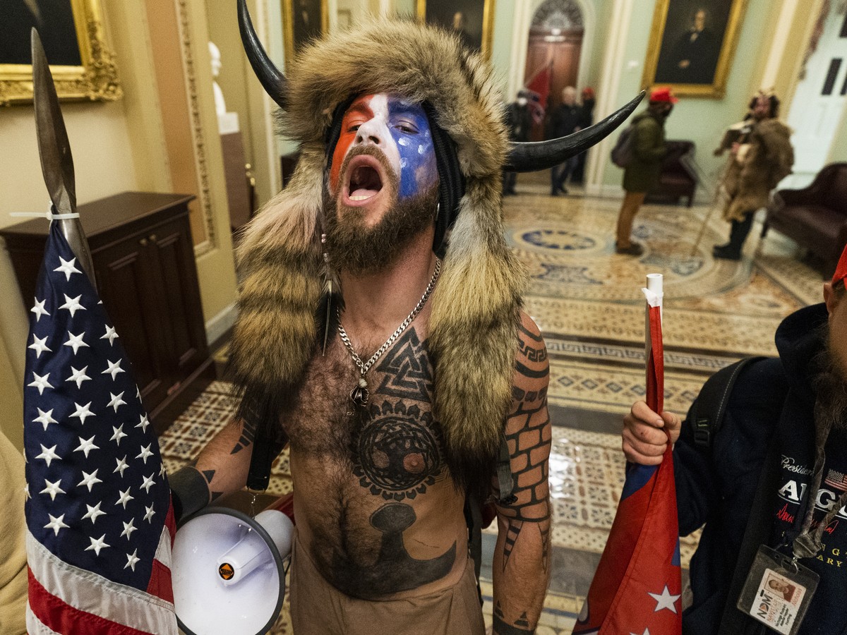 Jacob Anthony Chansley, center, with other insurrectionists who supported then-President Donald Trump, are confronted by U.S. Capitol Police in the hallway outside of the Senate chamber in the Capitol ...