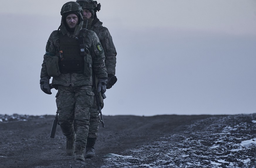 Ukrainian soldiers go to their position in the frontline close to Bakhmut, Donetsk region, Ukraine, Thursday, Feb. 9, 2023. (AP Photo/Libkos)