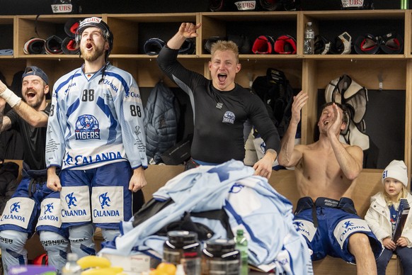Straubing`s JC Lipon, left, and Straubing`s Marrcel Brandt, center, celebrate after the semifinal game between Team Canada and Germany&#039;s Straubing Tigers at the 96th Spengler Cup ice hockey tourn ...
