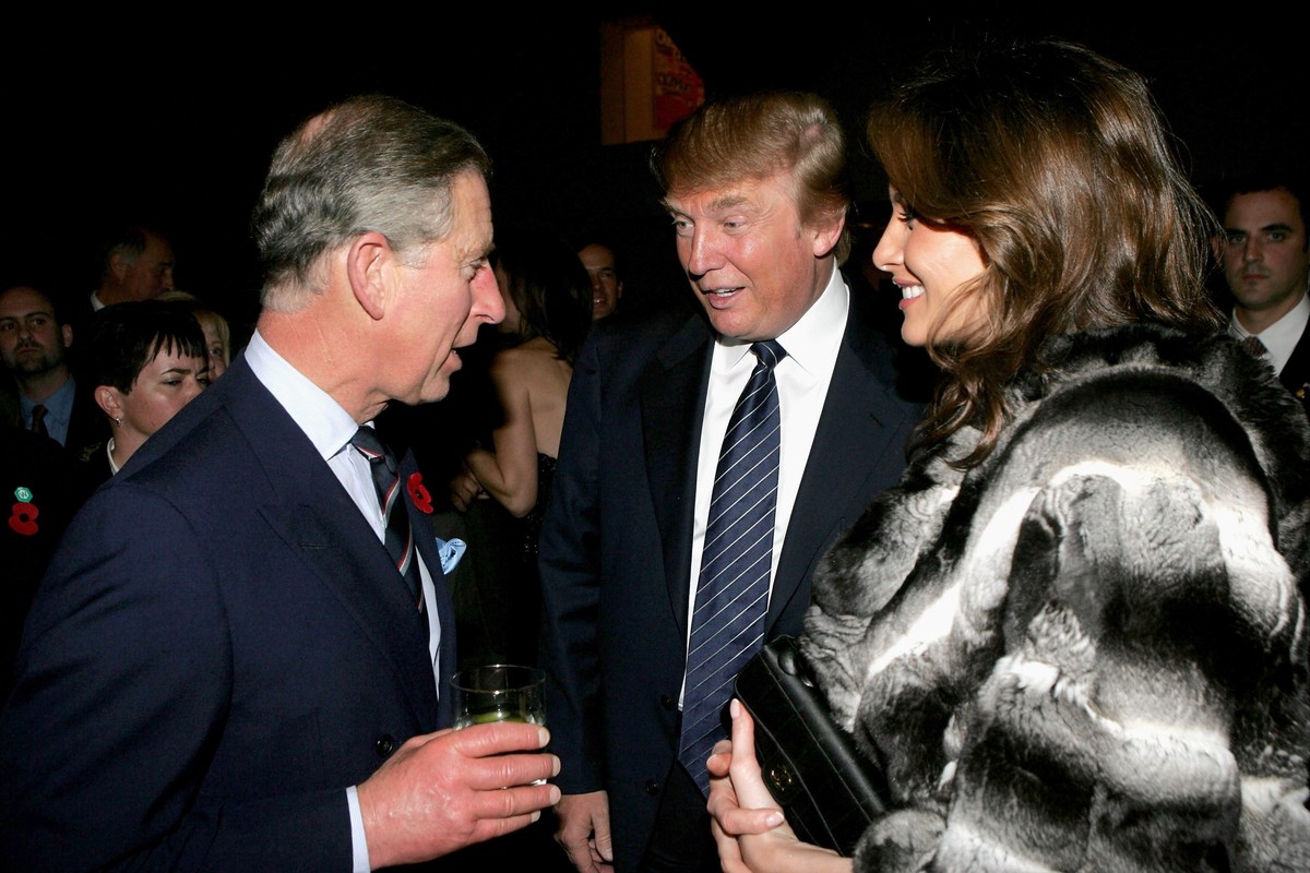 NEW YORK - NOVEMBER 01: Prince Charles (L) chats with businessman Donald Trump and his wife, Melania Trump, during the Museum of Modern Art (MOMA) reception on the first day of the royal eight-day vis ...