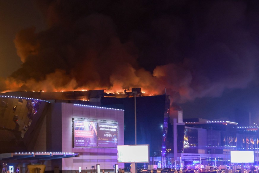 Russia: Crocus City Hall near Moscow in aftermath of shooting RUSSIA, MOSCOW REGION - MARCH 22, 2024: Smoke rises over the Crocus City Hall in the town of Krasnogorsk where unidentified persons opened ...