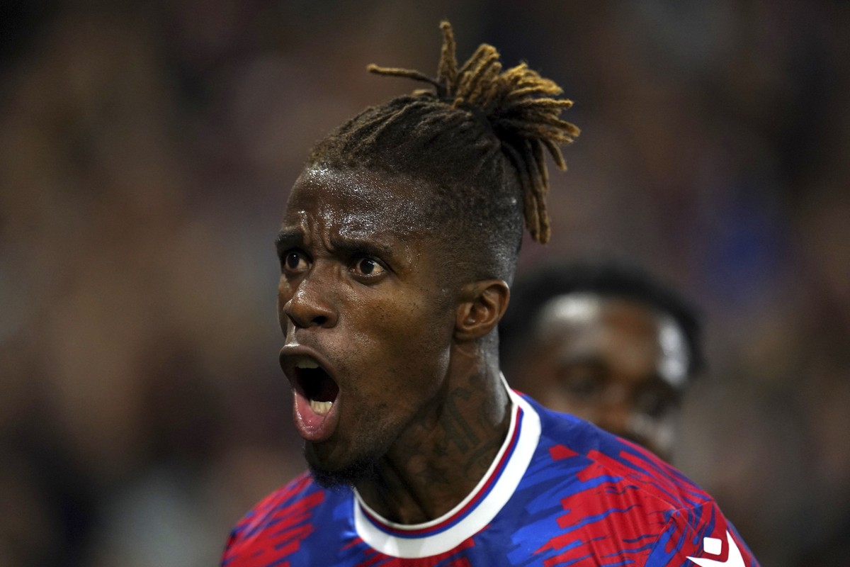 Crystal Palace's Wilfried Zaha celebrates scoring the opening goal during the English Premier League soccer match between Crystal Palace and Brentford at Selhurst Park, London, Tuesday Aug. 30, 2 ...