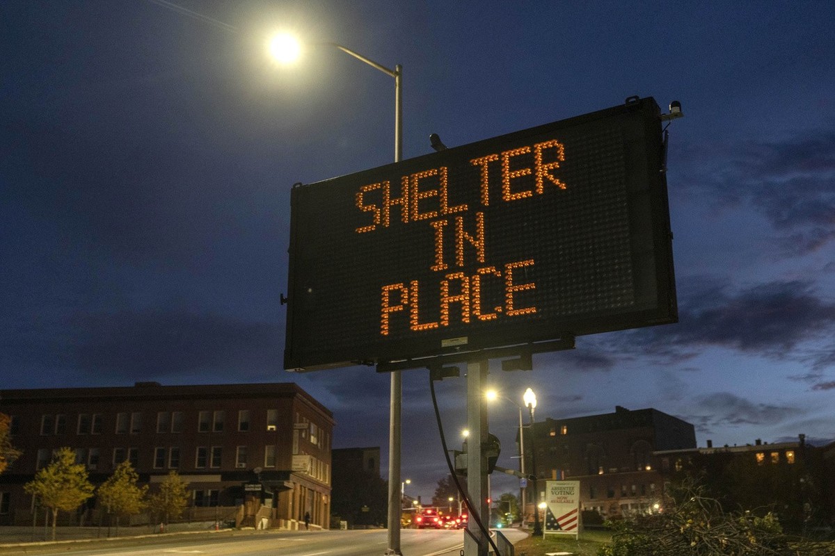 A sign advises residents to stay home, Thursday, Oct. 26, 2023, following a mass shooting at a restaurant and a bowling alley in Lewiston, Maine. Police continue to search for the suspect. (AP Photo/R ...