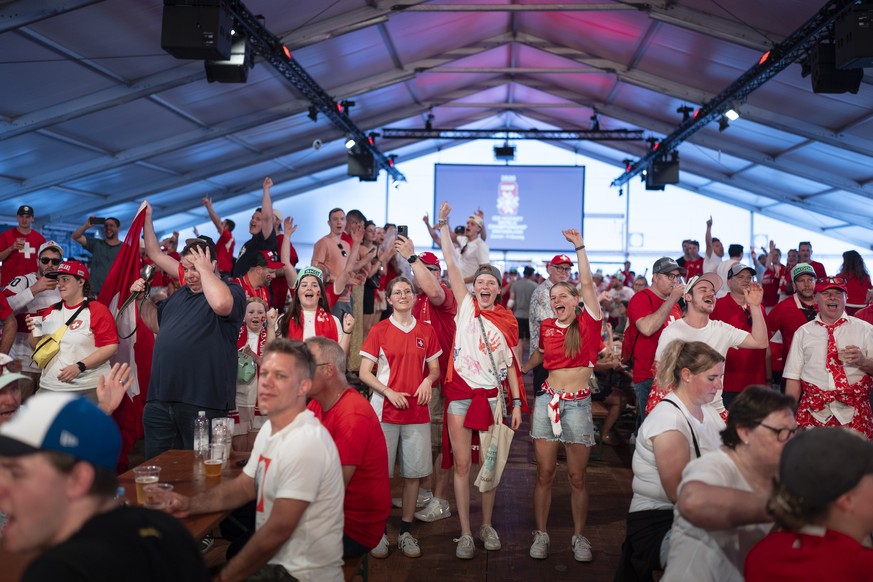 epa12995808 Swiss fans party in a tent in the fanzon prior to the 2026 IIHF Men's Ice Hockey World Championship preliminary round Group A game between Switzerland and Finland, in Zurich, Switzerl ...