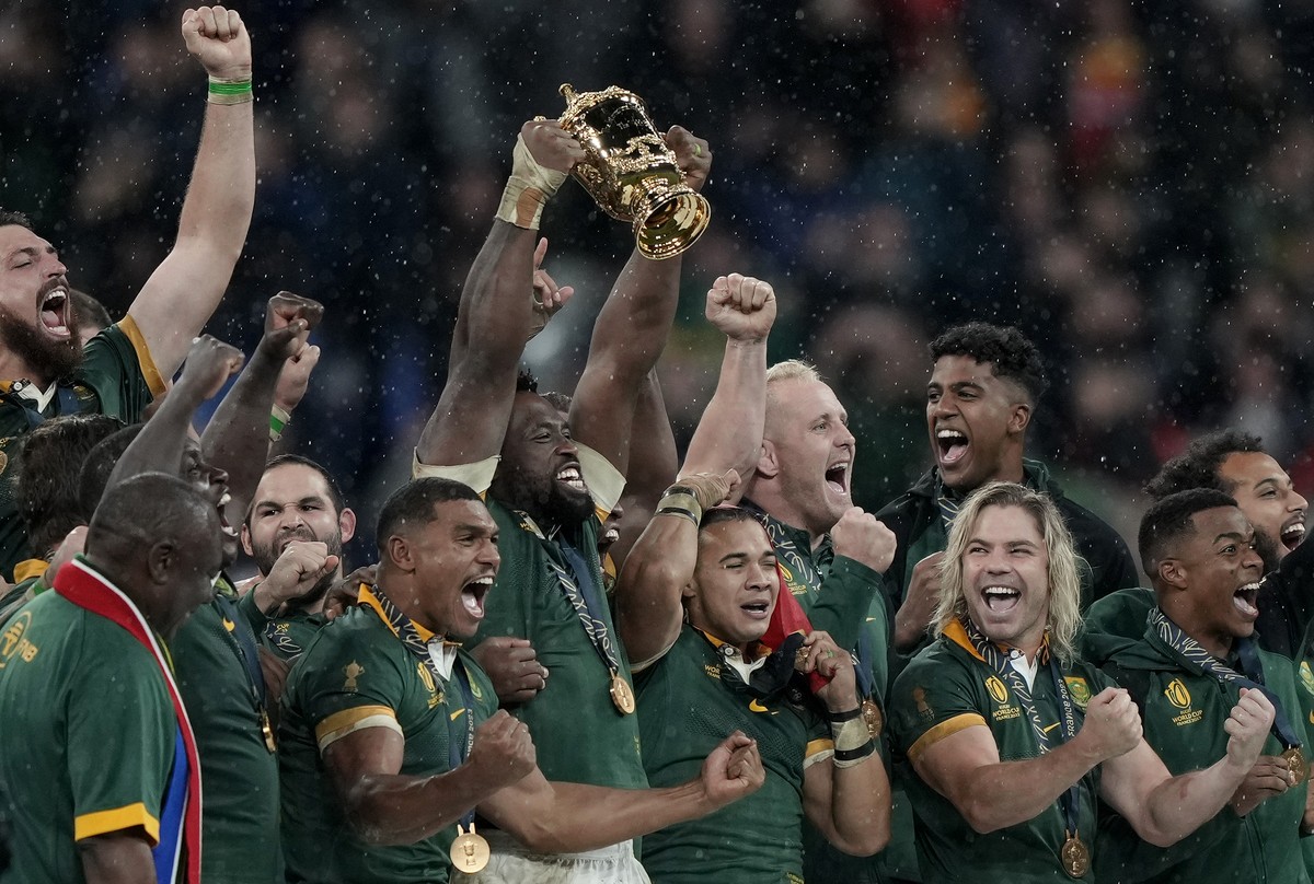 South Africa's players celebrate with the winner's trophy after winning the Rugby World Cup final match between against New Zealand at the Stade de France in Saint-Denis, near Paris Saturday ...