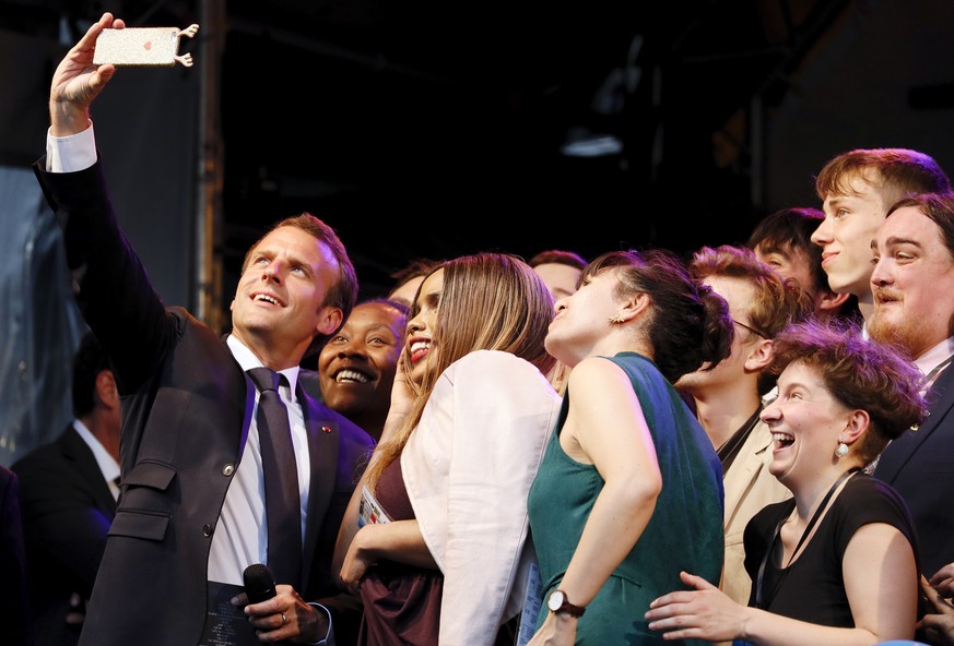 epaselect epa06723419 French President Emmanuel Macron (L) poses for a selfie with National Winners of the European Charlemagne Youth Prize on the eve of the Charlemagne Prize in Aachen, Germany, 09 M ...