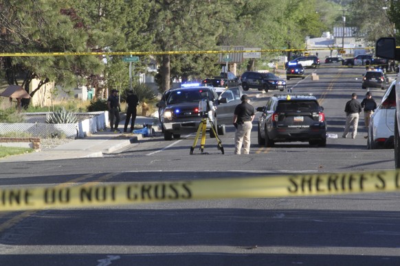 Investigators work along a residential street after a deadly shooting Monday, May 15, 2023 in Farmington, NM.  Authorities said an 18-year-old opened fire in the northwestern New Mexico community…