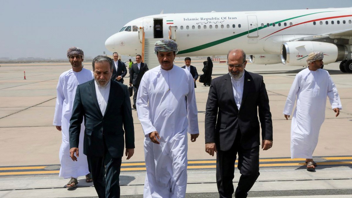 FILE - In this photo released by the Iranian Foreign Ministry, Iranian Foreign Minister Abbas Araghchi, left, is welcomed by an unidentified Omani official, center, upon his arrival at Muscat, Oman, f ...