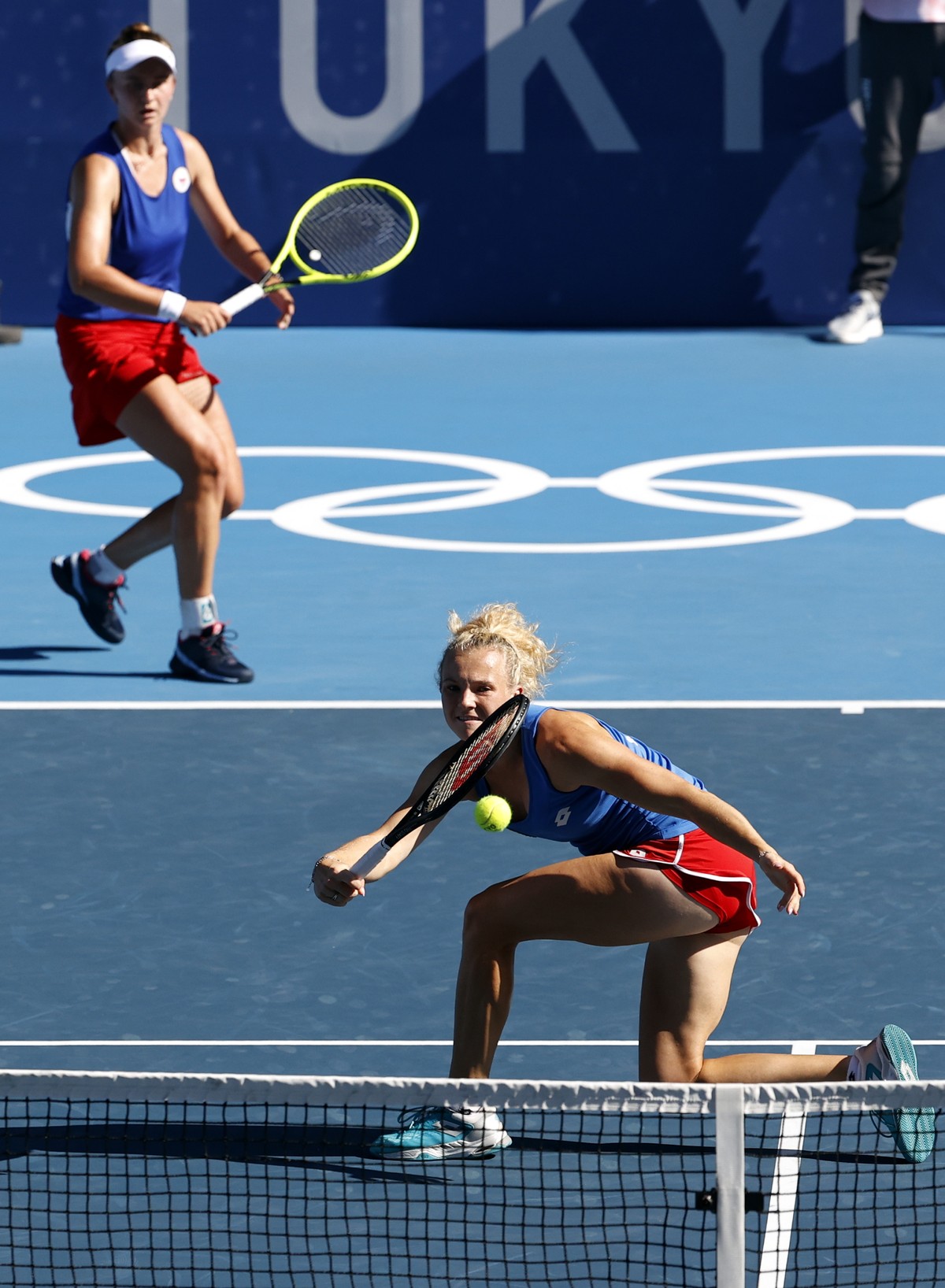 epa09384230 Barbora Krejcikova (L) and Katerina Siniakova (R) of Czech Republic in action during the Women's Doubles gold medal match during the Tennis events of the Tokyo 2020 Olympic Games at t ...