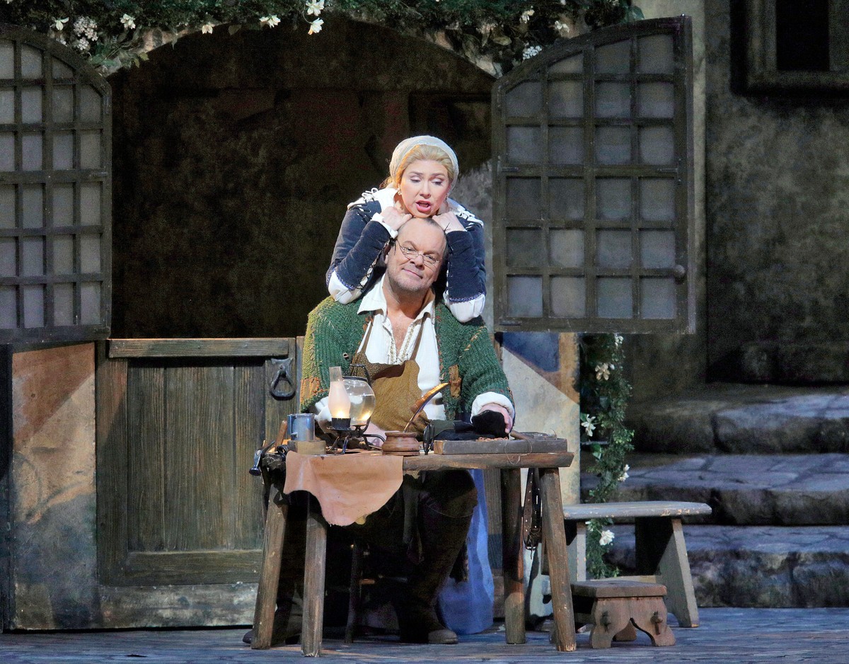 In this Dec. 9, 2014 photo released by the Metropolitan Opera, Michael Volle, seated, and Annette Dasch appear during a performance of "Die Meistersinger von Nürnberg," in New York. (AP Phot ...