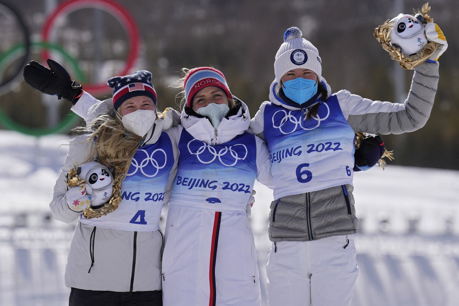 From left, silver medal finisher Jessie Diggins, gold medal finisher Norway's Therese Johaug and bronze medal finisher Finland's Kerttu Niskanen pose during a venue ceremony after the women& ...