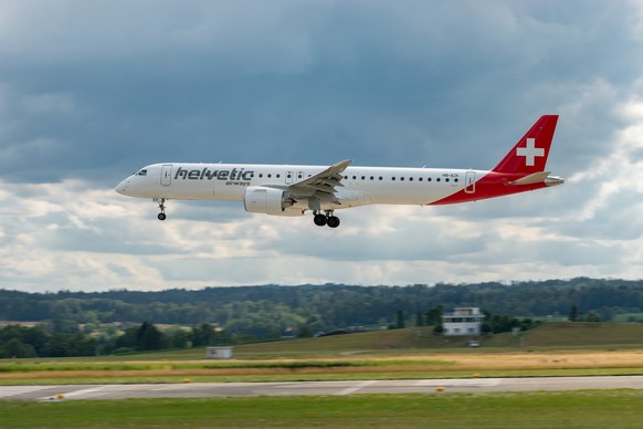 Zurich, Switzerland, July 13, 2023 HB-AZK Helvetic Airways Embraer E195-E2 aircraft is landing on runway 14 xkwx zurich switzerland airport international flight aircraft plane travel transportation sp ...