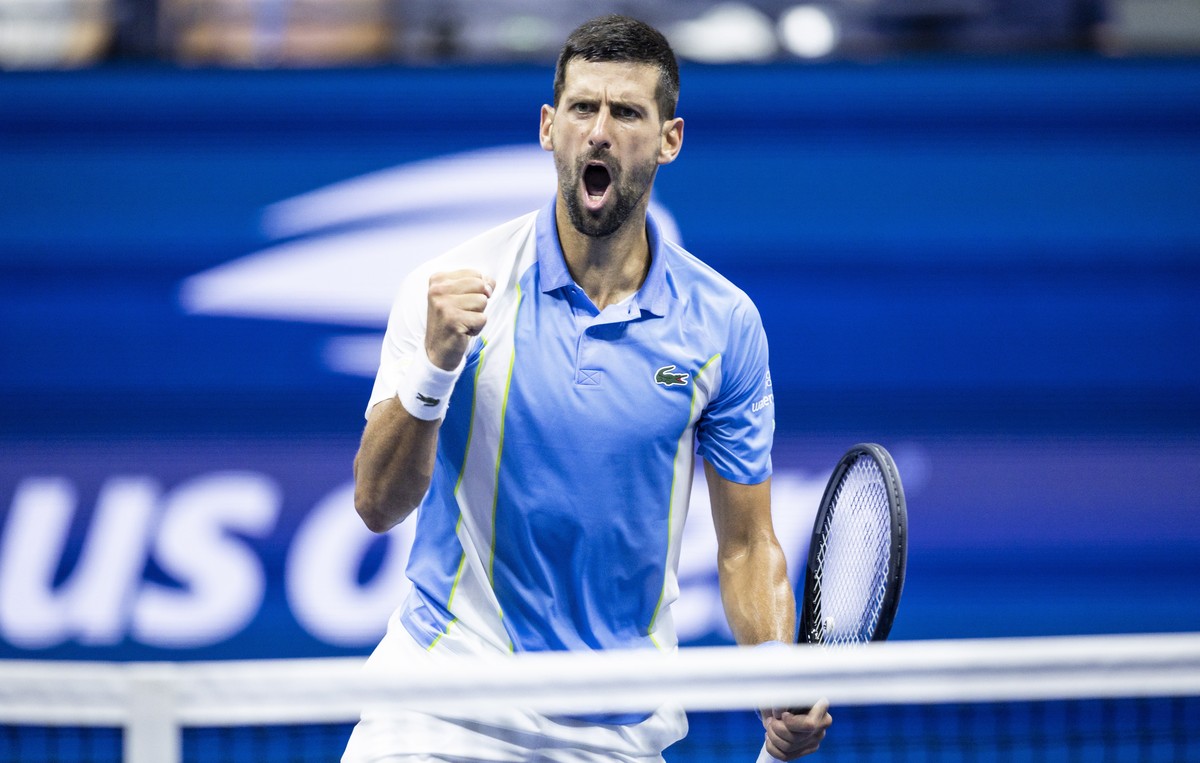 epa10849713 Novak Djokovic of Serbia react to winning a point against Ben Shelton of the United States during their men's singles semifinal round match during the US Open Tennis Championships at  ...