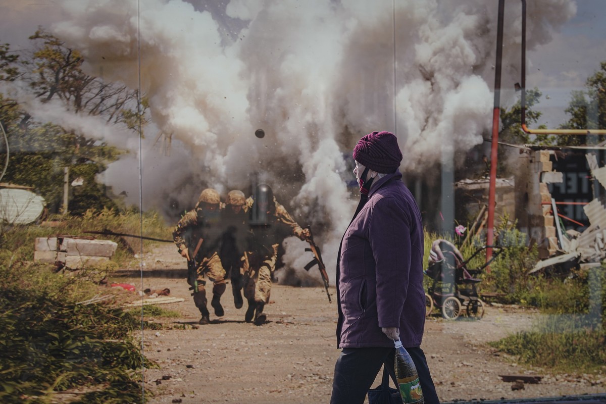 A woman walks by a photographic memorial for those killed in the confrontation between Ukraine's military and the pro-Russia separatist forces in Sievierodonetsk, Luhansk region, eastern Ukraine, ...